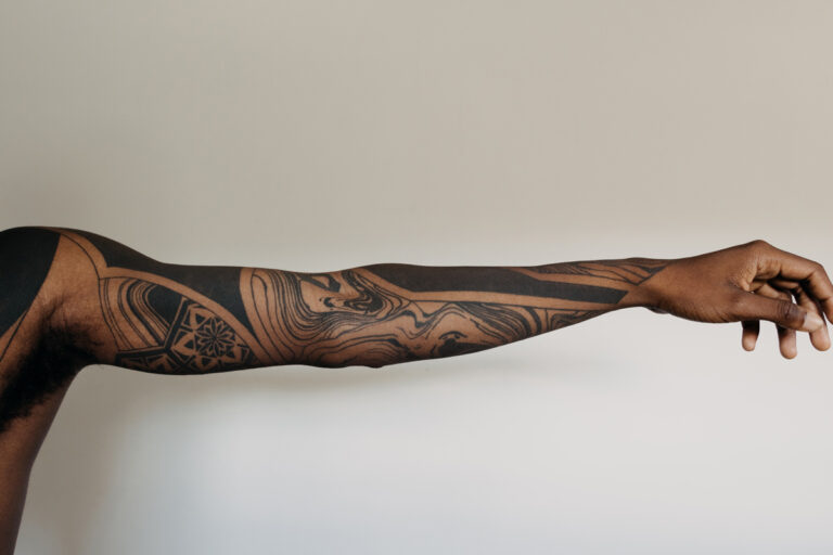 Geometric and blackout sleeves tattoo.